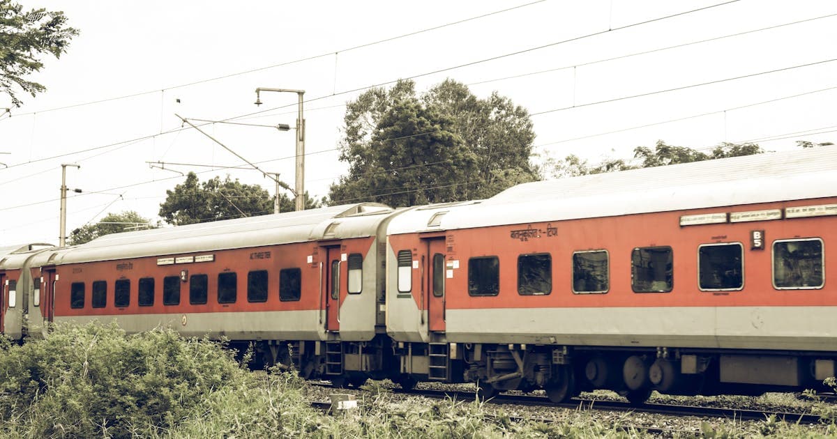 Indian train running through rural countryside showing available coaches