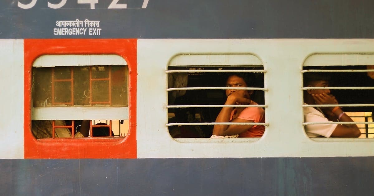 Checking PNR status on a smartphone at the railway station